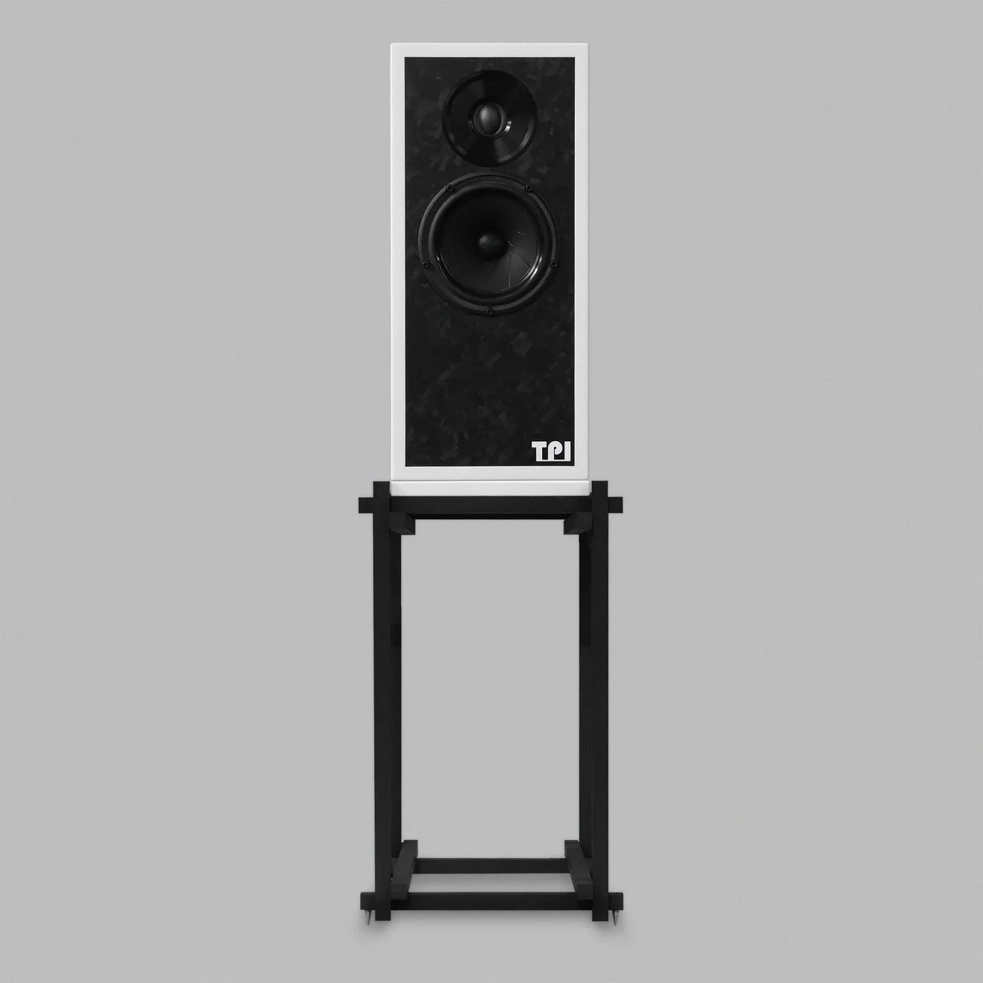 Type. HF1 on its stand, from the front: a white cabinet with a black speckled baffle holding a tweeter above a mid-bass driver, on an open black stand made from square-section bars.