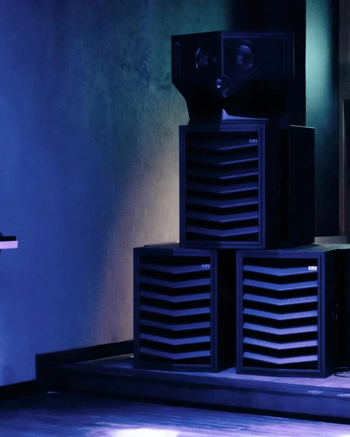 A black Type. MFR at Beam Cube: the horn module on a tall slatted cabinet, standing on two slatted MFR Sub cabinets.