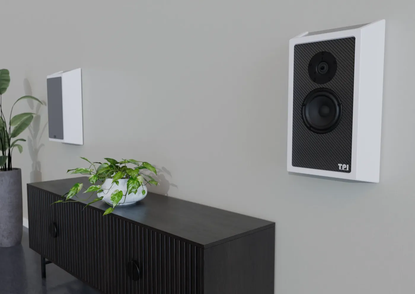 A white wall-mounted speaker with an angled cabinet beside a TV unit in a living room.