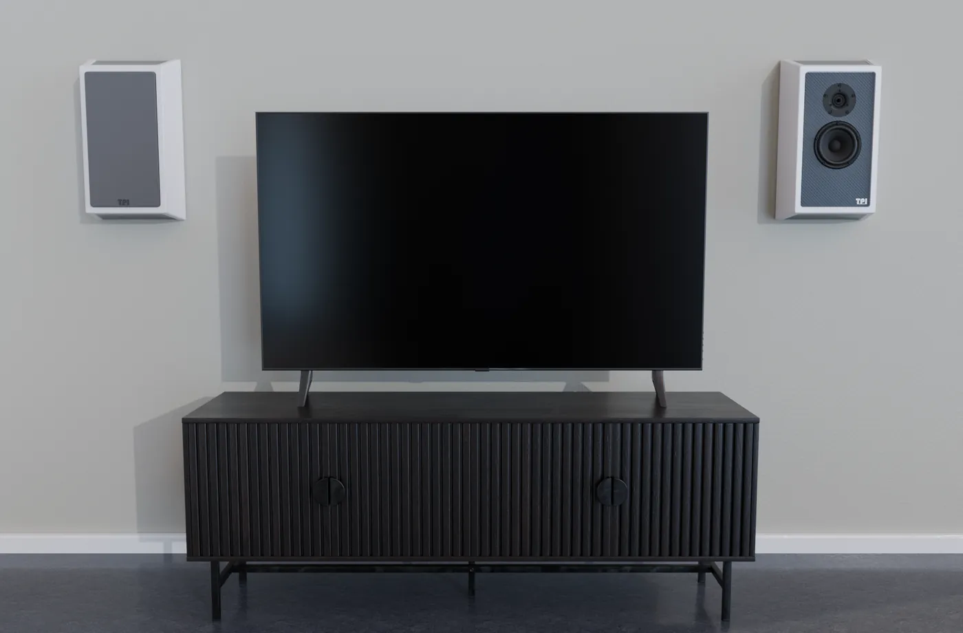Render of a living room: a pair of Picture speakers on the wall either side of a TV standing on a dark sideboard, one with its grille fitted.
